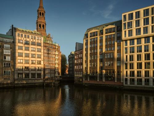Brick warehouse frontage beside a narrow canal in daylight