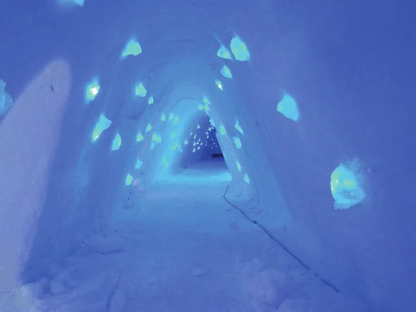Carved snow hall lit in pale blue light