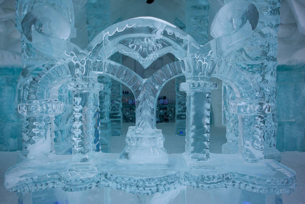 Snow-built vaulted corridor with carved openings on both sides