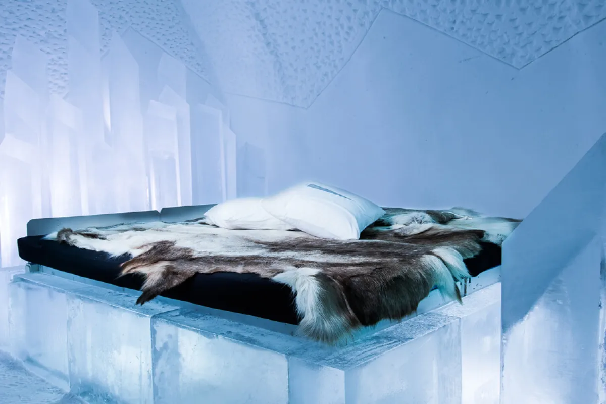 Carved ice wall and a bed platform inside a hall of ice