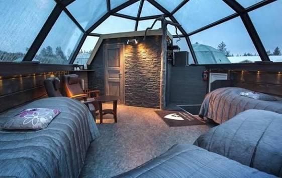Snow-walled sleeping room with a bed platform and low lighting